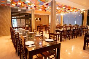 a dining room with a long table and chairs at Hotel Divine Light Monaragala in Monaragala +25 photos