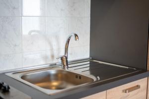 a kitchen sink with a faucet on a stove at Suliventumari in Ribera +36 photos