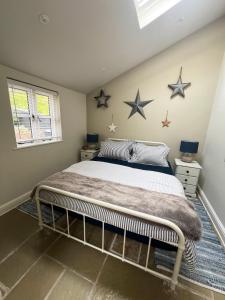 a bedroom with a bed with stars on the wall at The Leat at The Old Mill in Tavistock