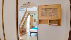 a mirror in a room with a bed and a ladder at Bom Dia Siargao Villas in General Luna +96 photos