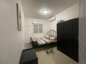 a small bedroom with a bed and a window at NOMADIA MOUSSa in Pamandzi