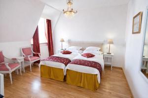 a bedroom with a large bed and two chairs at Brommavik Hotel in Stockholm +41 photos