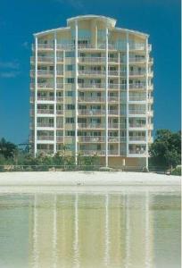 a large building next to a body of water at Riviere on Golden Beach in Caloundra