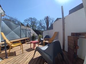 a patio with chairs and a table on a deck at la demeure des songes in Josselin