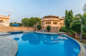 a large swimming pool in front of a house at Bijainagar Fort in Jāmb