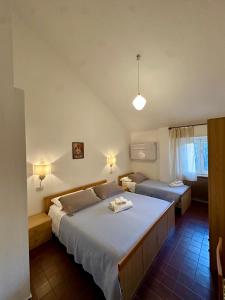 a bedroom with a large bed in a room at Hotel La Pineta in Cogoleto