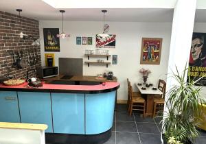 a kitchen with a blue island in a room at Le loft - hypercentre de Tours in Tours