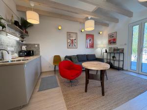 a living room with a red chair and a table at ZadorHomes Etyek in Etyek