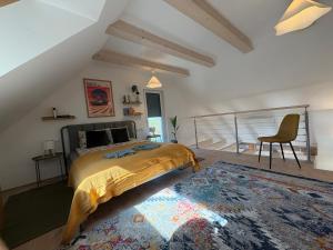 a bedroom with a bed and a chair and a rug at ZadorHomes Etyek in Etyek