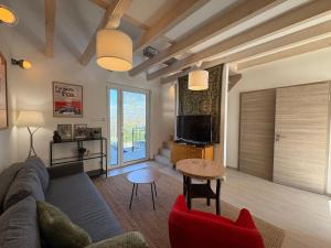 a living room with a couch and a table at ZadorHomes Etyek in Etyek