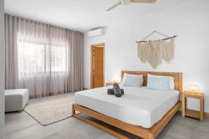 a bedroom with a large bed and a window at Golden Bloom - High-End Duplex w Private Pool in Rivière Noire