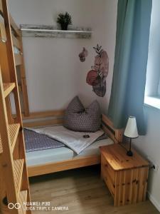 a room with a bunk bed and a table at Ferienwohnung am Schlosspark in Potsdam +3 photos