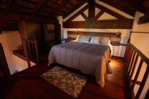 a bedroom with a large bed in a room at Finca La Marta - El Cortijo Wine Lodge in Capilla del Monte