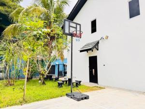 a basketball hoop in front of a white building at uncommon homestay in Klang