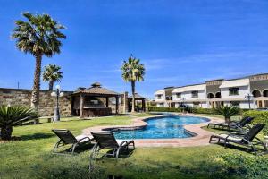 a swimming pool in a yard with chairs and a gazebo at Arroyos del Paraíso Residencial Suite C in Manuel F. Martínez +3 photos