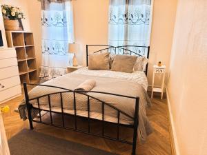 a bedroom with a bed in a room with blue curtains at Central Reading Cozy Spacious Room in Reading