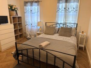 a bedroom with a bed and a tv and windows at Central Reading Cozy Spacious Room in Reading