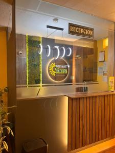 a restaurant with a counter with a sign on it at Hostal Terra 3 - BASE AÉREA in Quito