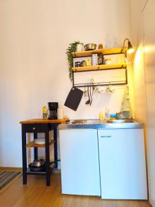 a kitchen with a sink and a table at Studio, Fireplace, Super location, Free Parking in Tallinn