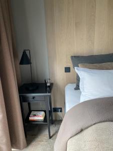 a bedroom with a bed and a table with a lamp at Efri Torfa - Luxury in Nature - Peaceful & Cosy in Kirkjubæjarklaustur