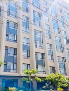 a tall building with many windows on it at Tripstar villa studio at Tsavo sunset Kiambu Road Thindigua in Kiambu