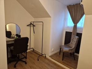 a room with a desk and a mirror and a chair at Järnvägshotellet Charlottenberg in Charlottenberg +1 photo