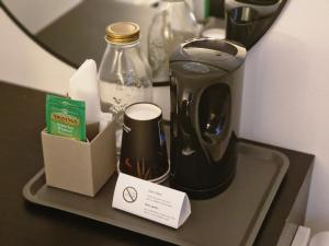 a coffee maker and a box on a tray at Järnvägshotellet Charlottenberg in Charlottenberg