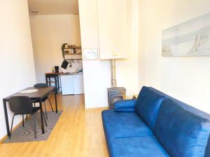 a living room with a blue couch and a table at Studio, Fireplace, Super location, Free Parking in Tallinn