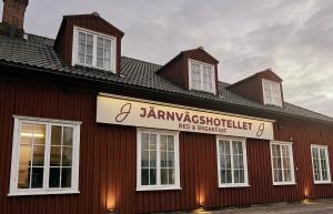 a building with a sign on the side of it at Järnvägshotellet Charlottenberg in Charlottenberg