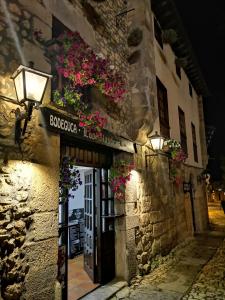 a building with flowers on the side of it at Casa Gelín Azul in Santillana del Mar