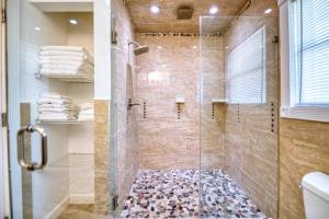 a bathroom with a shower with a glass door at Waterfront oasis 3BR Game Room Pet Friendly in Little Egg Harbor Township