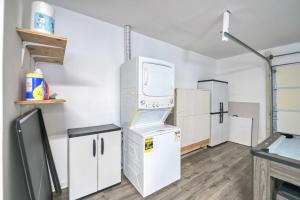 a laundry room with white cabinets and a washer and dryer at Waterfront oasis 3BR Game Room Pet Friendly in Little Egg Harbor Township