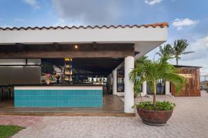 a building with a pool in front of a restaurant at Ocean Coral & Turquesa All Inclusive in Puerto Morelos