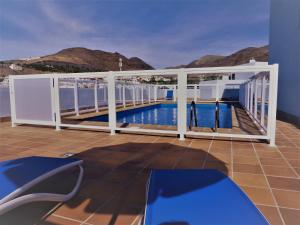 a balcony with a view of a swimming pool at galina blanco sosite in Morro del Jable