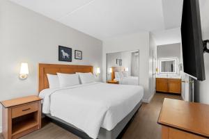 a bedroom with a large white bed and a desk at Sonesta ES Suites Phoenix Goodyear in Goodyear +34 photos