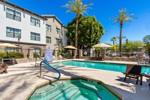 a swimming pool in front of a building at Sonesta ES Suites Phoenix Goodyear in Goodyear
