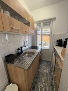 a small kitchen with a sink and a window at Erika Vendégház in Igal