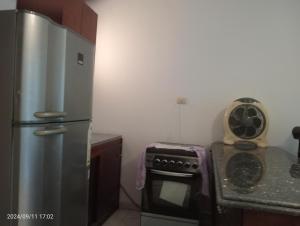 a kitchen with a refrigerator and a stove at Royal Chalet Sea View - Stella Di Mare - Families in Az Zafarani