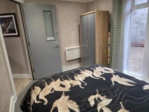 a bedroom with a bed with a blue comforter with dragons on it at Levy Nook 6 in Darlington