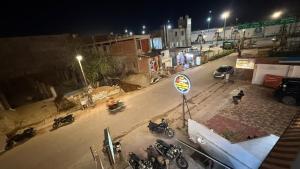 an overhead view of a street at night with motorcycles at Utkarsh Palace And Restaurant in Ayodhya Ghā