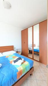 a bedroom with a large bed with a colorful comforter at Bosco Di Lago in Solto Collina