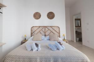 a bedroom with a large bed with three pillows at Giosuero Beach in Alghero +135 photos