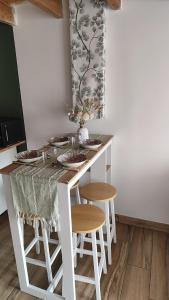 a kitchen with a table and two stools at Studio Dennebroeucq in Dennebroeucq