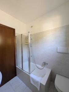 a bathroom with a shower and a tub and a toilet at Bosco Di Lago in Solto Collina
