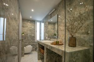 a bathroom with a sink and a toilet at Agora Luxury Suites in Lixouri +37 photos