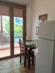 a kitchen with a table and a refrigerator at IZEΛA Hotel in Kala Nera
