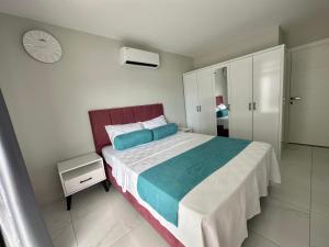 a bedroom with a bed and a clock on the wall at ARCADIA Homes in Alanya +35 photos