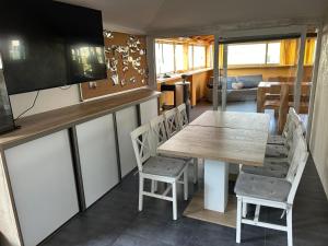 a kitchen with a table and chairs in a room at MAX apartmán jazero in Trstice +12 photos