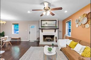 a living room with a couch and a fireplace at Sun-Filled and Spacious One-Level Buckhead Oasis in Atlanta