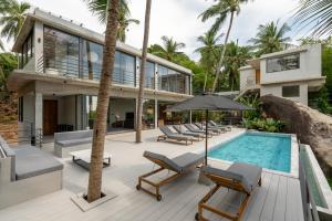 an exterior view of a house with a swimming pool at Palm Stone Villa in Haad Pleayleam